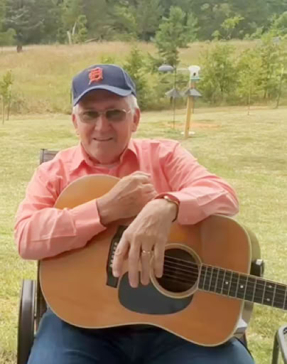 Zach, HCBA Webmaster with guitar.
