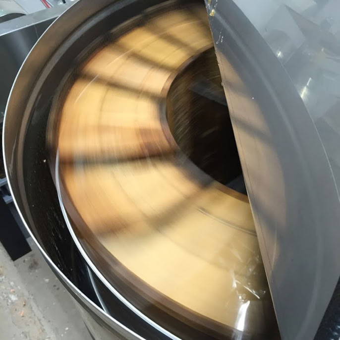 Close-up of a honey extractor spinning frames of honey.